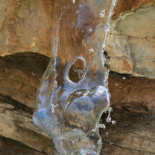water flowing out of a rock